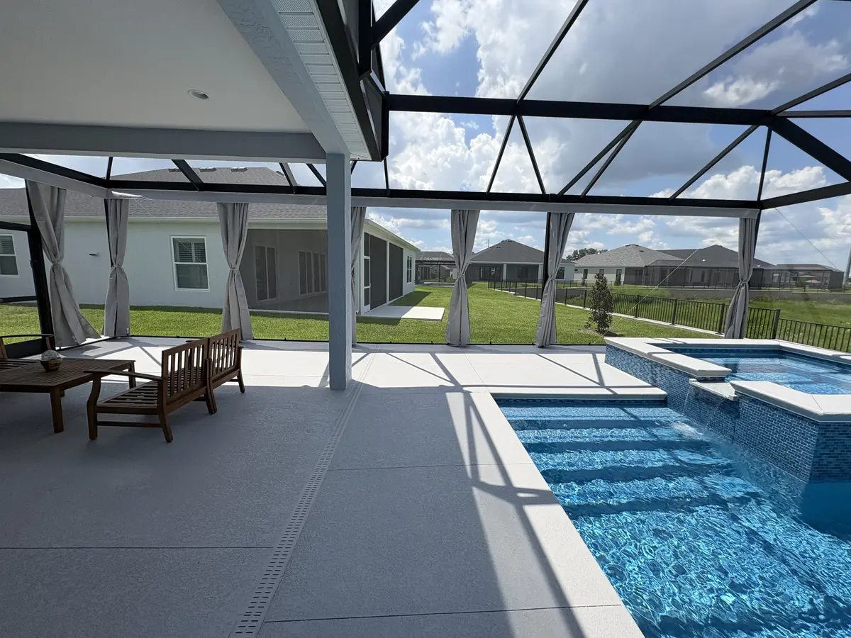 Gray tie-back privacy curtains on a lanai with a spa and pool