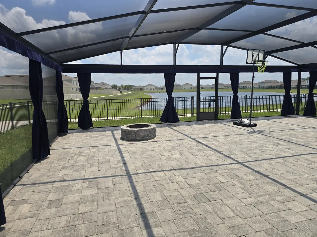 Navy tie-back privacy curtains around a paver patio with a fire pit