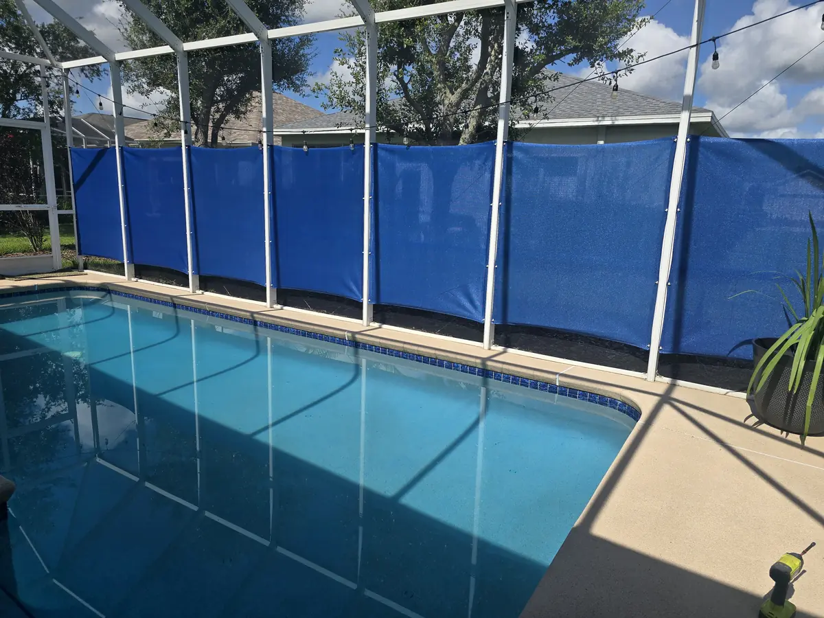 Royal blue privacy curtains along the side of a pool cage in Florida