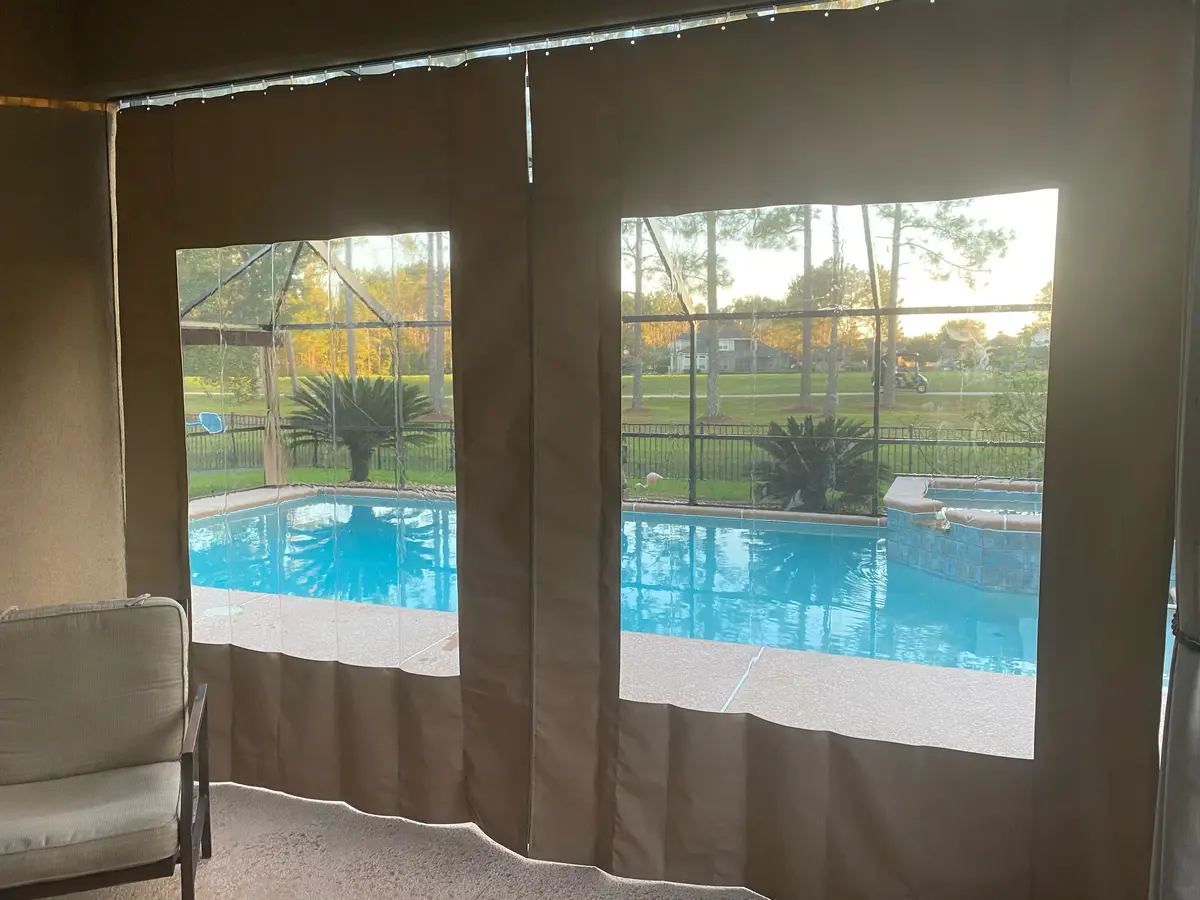 Canvas curtains with vinyl windows in Florida lanai overlooking pool