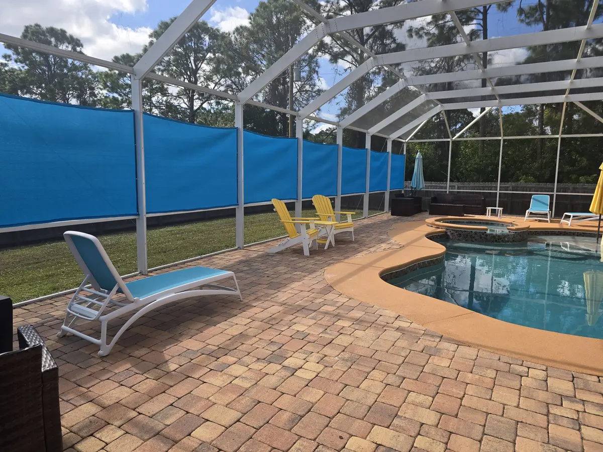 UV-stabilized privacy panels around paver patio Florida pool area