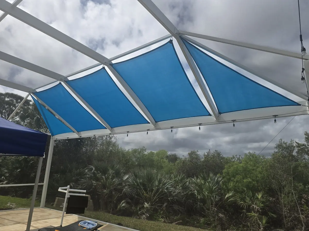 Row of blue shade sails along the roof of a Florida screen enclosure